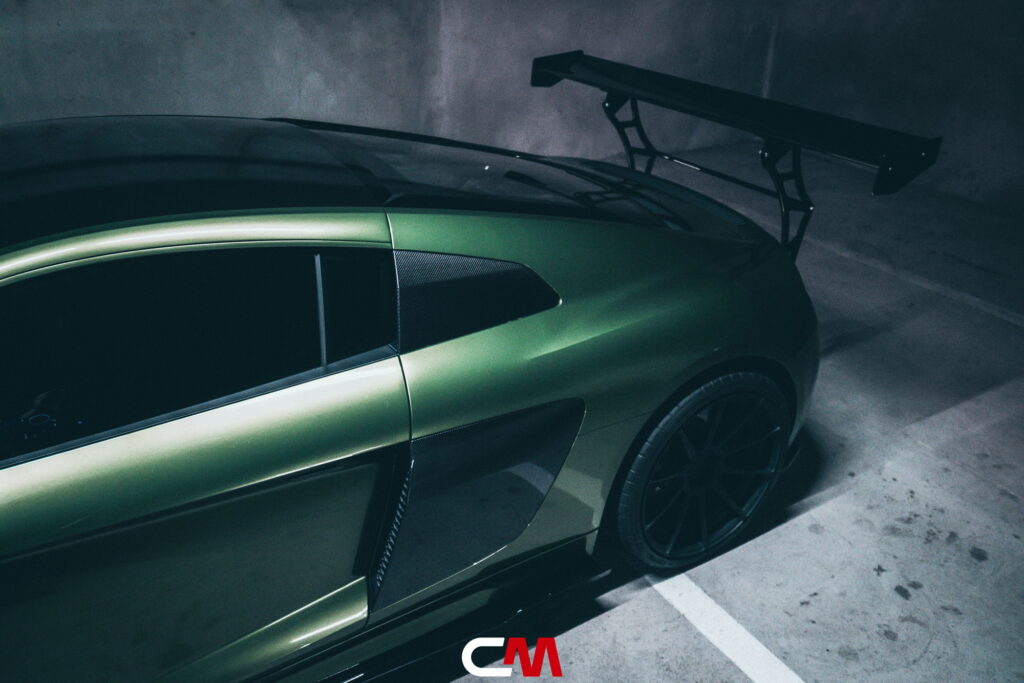 Green Audi R8 V10 with a carbon fiber hood and custom rear wing fitted by California Motorsports