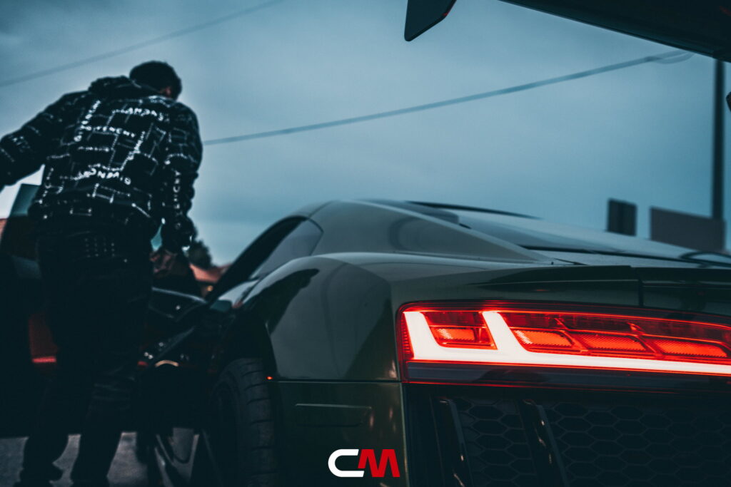 Green Audi R8 V10 with a carbon fiber hood and custom rear wing fitted by California Motorsports