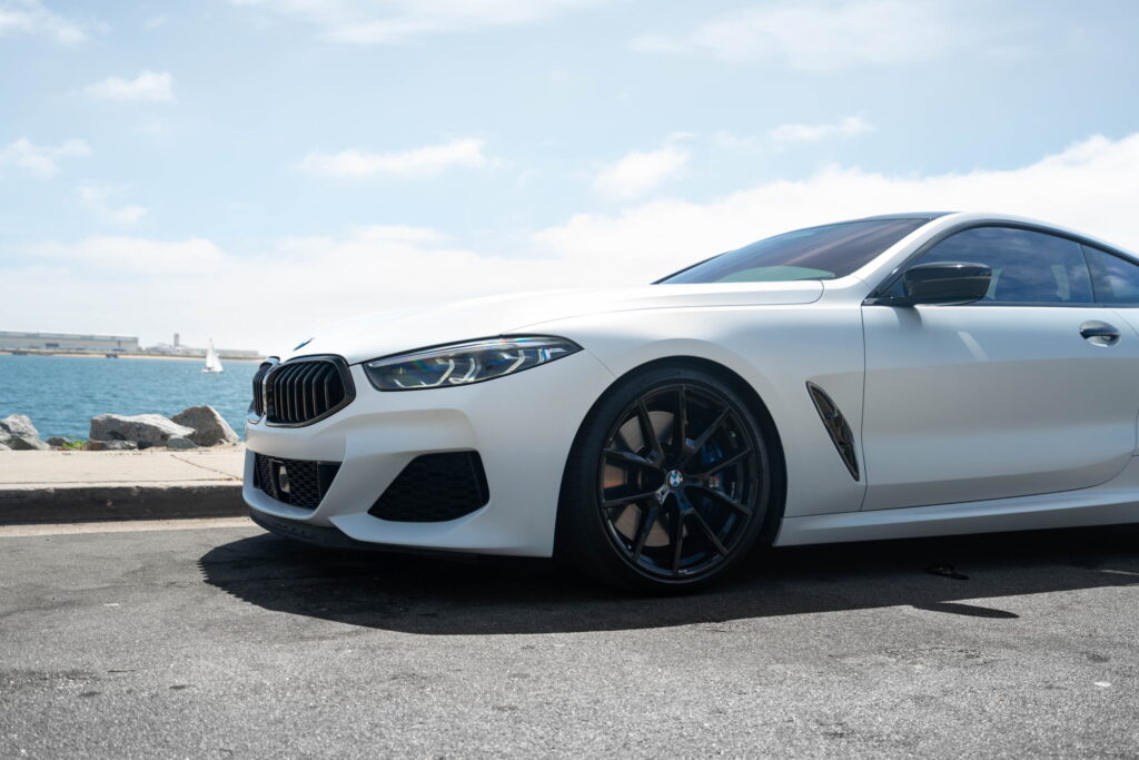 BMW M850i in a Satin Flip Ghost Pearl color-change wrap with H&R lowering springs by California Motorsports