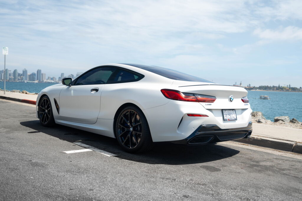 BMW M850i in a Satin Flip Ghost Pearl color-change wrap with H&R lowering springs by California Motorsports