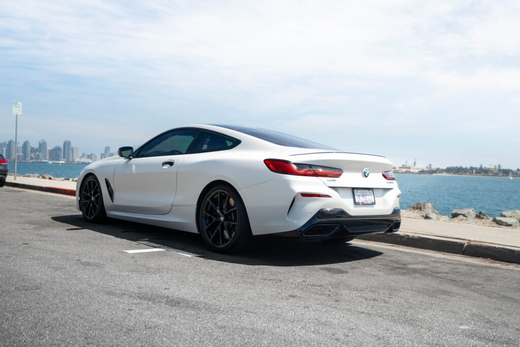 BMW M850i in a Satin Flip Ghost Pearl color-change wrap with H&R lowering springs by California Motorsports
