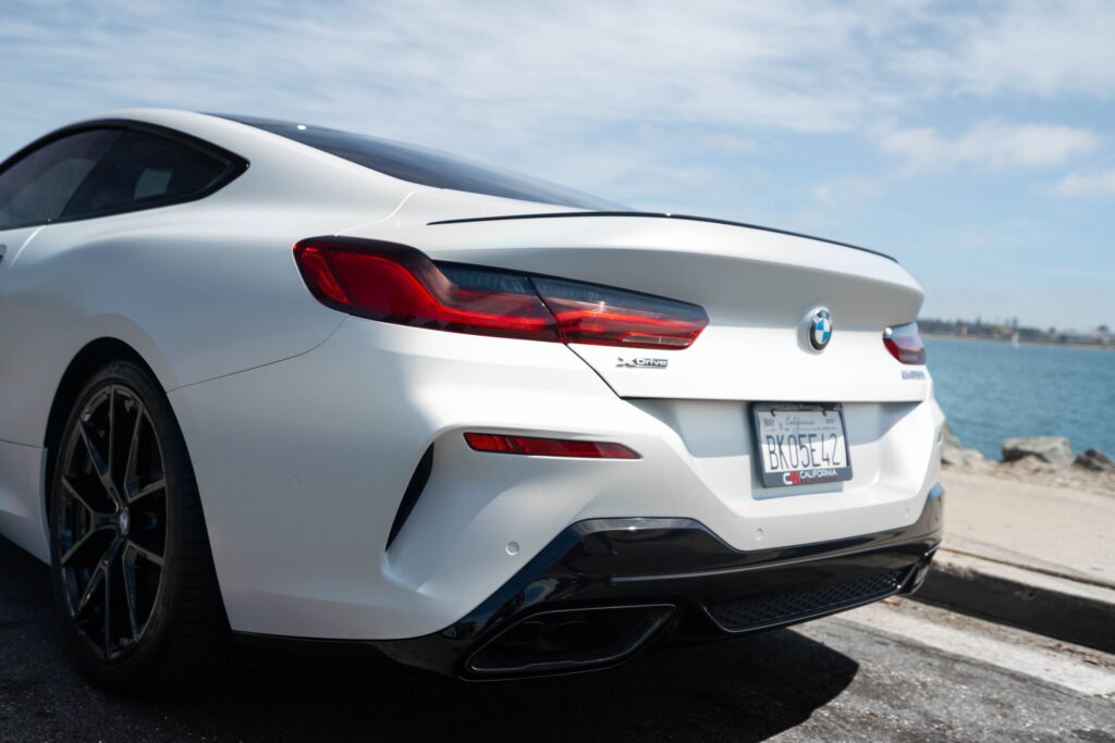 BMW M850i in a Satin Flip Ghost Pearl color-change wrap with H&R lowering springs by California Motorsports