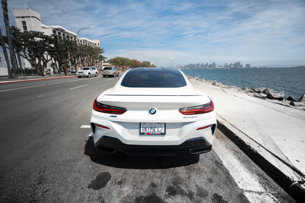 BMW M850i in a Satin Flip Ghost Pearl color-change wrap with H&R lowering springs by California Motorsports