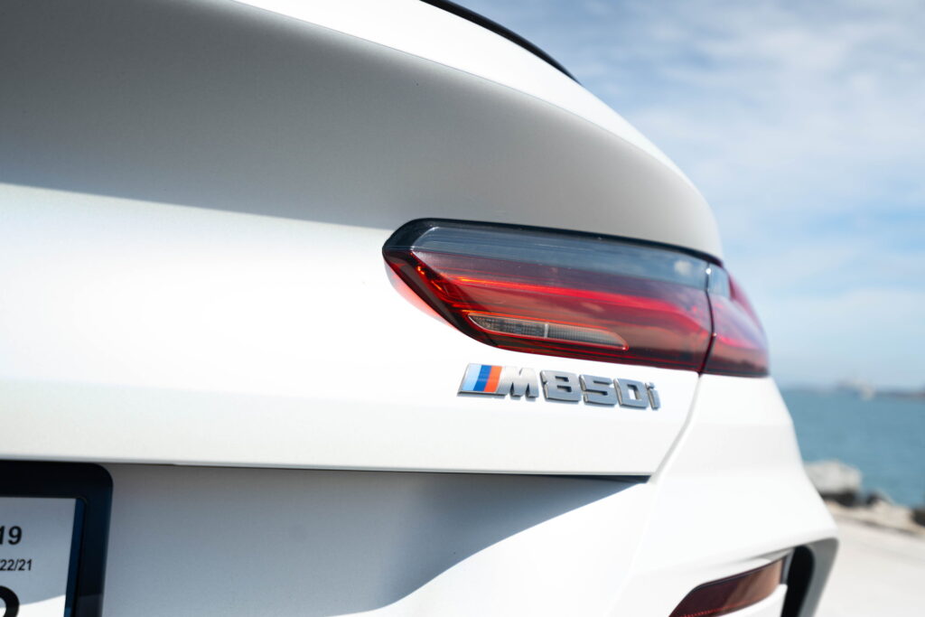 BMW M850i in a Satin Flip Ghost Pearl color-change wrap with H&R lowering springs by California Motorsports