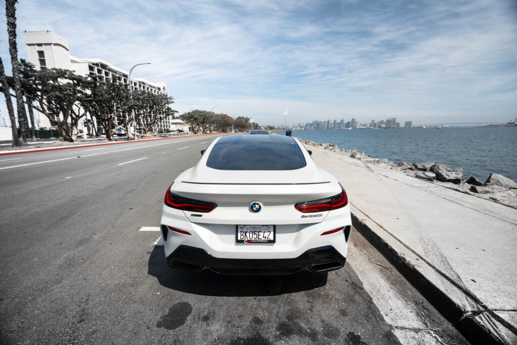 BMW M850i in a Satin Flip Ghost Pearl color-change wrap with H&R lowering springs by California Motorsports