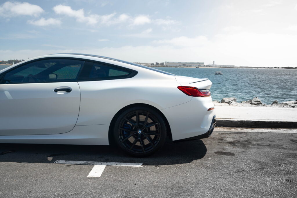 BMW M850i in a Satin Flip Ghost Pearl color-change wrap with H&R lowering springs by California Motorsports