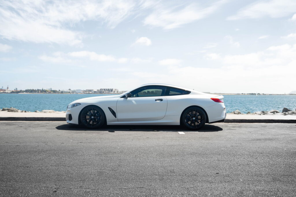 BMW M850i in a Satin Flip Ghost Pearl color-change wrap with H&R lowering springs by California Motorsports