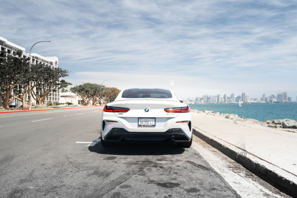 BMW M850i in a Satin Flip Ghost Pearl color-change wrap with H&R lowering springs by California Motorsports