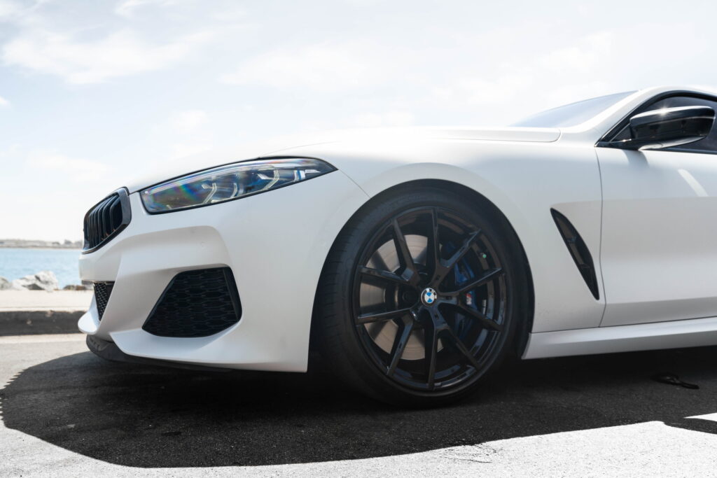 BMW M850i in a Satin Flip Ghost Pearl color-change wrap with H&R lowering springs by California Motorsports
