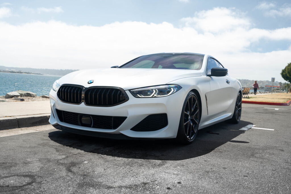 BMW M850i in a Satin Flip Ghost Pearl color-change wrap with H&R lowering springs by California Motorsports
