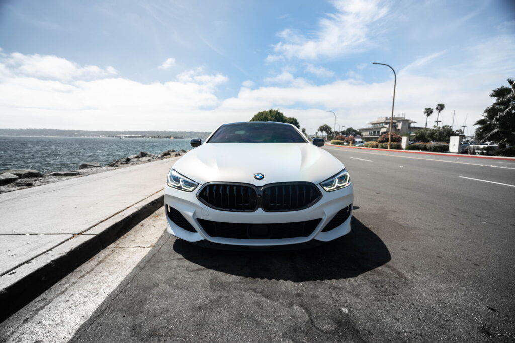 BMW M850i in a Satin Flip Ghost Pearl color-change wrap with H&R lowering springs by California Motorsports