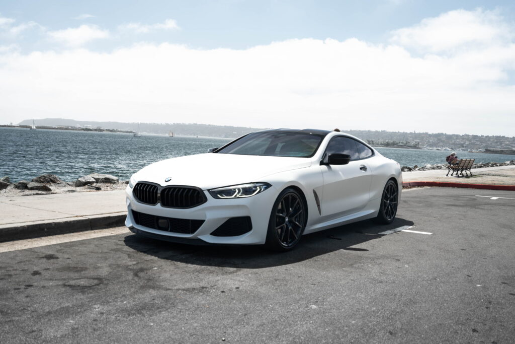 BMW M850i in a Satin Flip Ghost Pearl color-change wrap with H&R lowering springs by California Motorsports