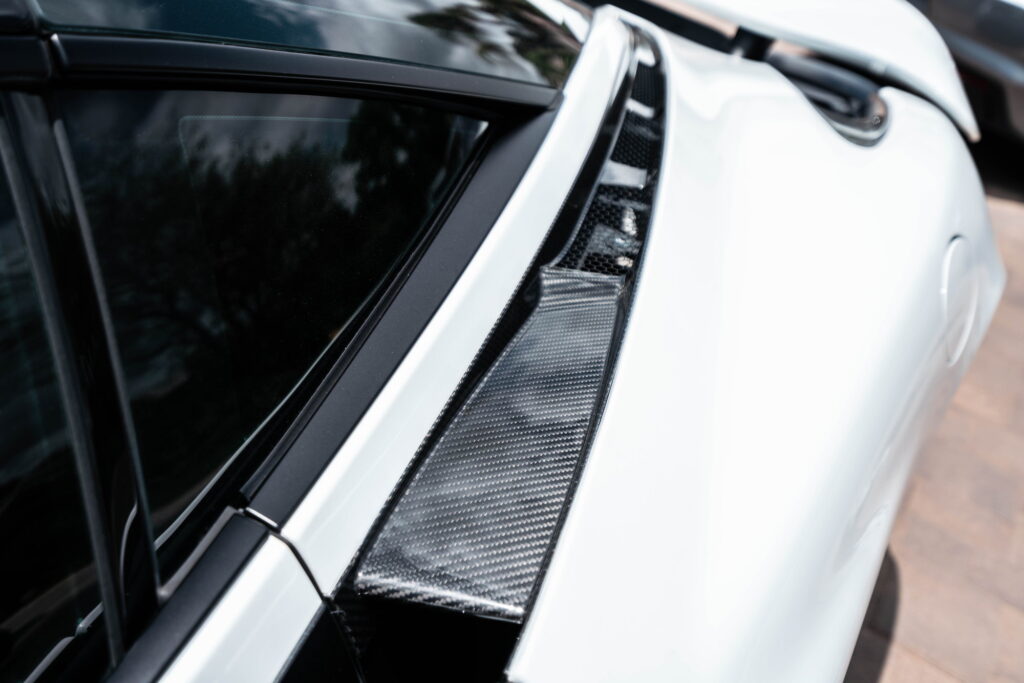 White McLaren 720S with carbon fiber mirror caps and side intake blades fitted by California Motorsports