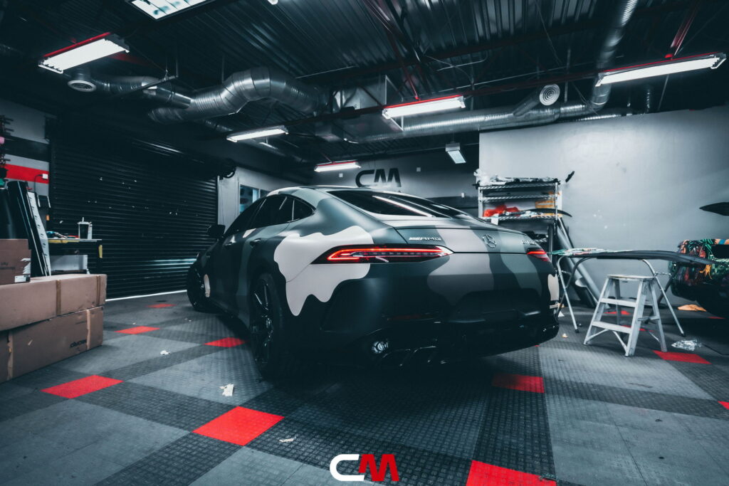 Mercedes-AMG GT 63 4-Door in a custom matte camo wrap being installed at California Motorsports, El Cajon