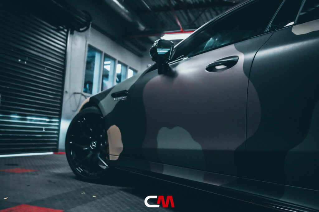 Mercedes-AMG GT 63 4-Door in a custom matte camo wrap being installed at California Motorsports, El Cajon