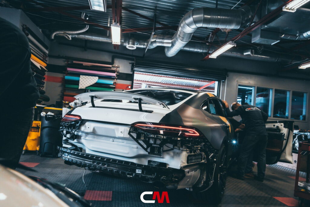 Mercedes-AMG GT 63 4-Door in a custom matte camo wrap being installed at California Motorsports, El Cajon