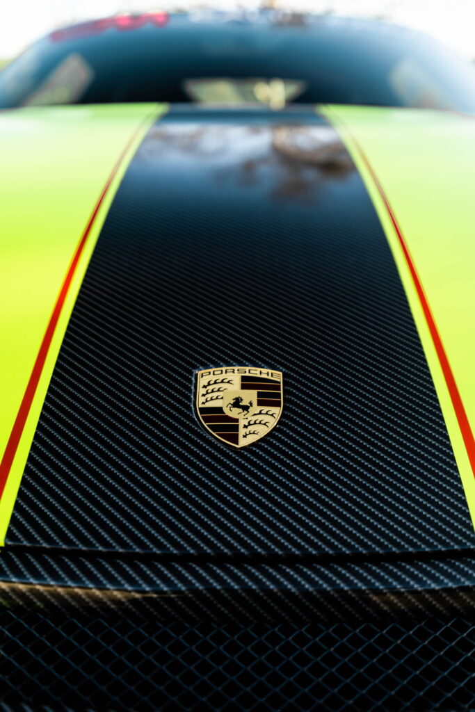 Porsche 911 GT3 in a gloss lime yellow color-change wrap with black stripes by California Motorsports