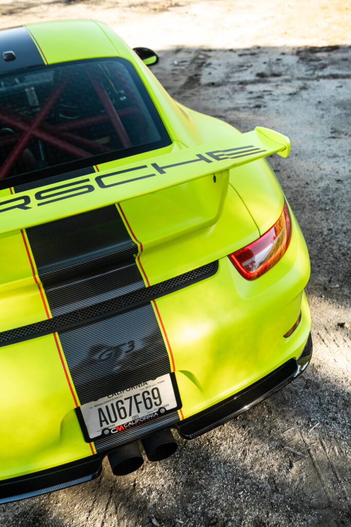 Porsche 911 GT3 in a gloss lime yellow color-change wrap with black stripes by California Motorsports