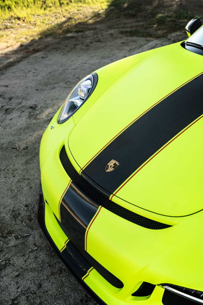 Porsche 911 GT3 in a gloss lime yellow color-change wrap with black stripes by California Motorsports